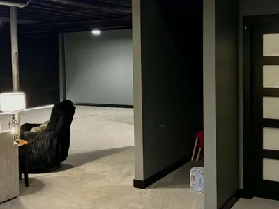 5-panel lighted door next to storage area under stairs.