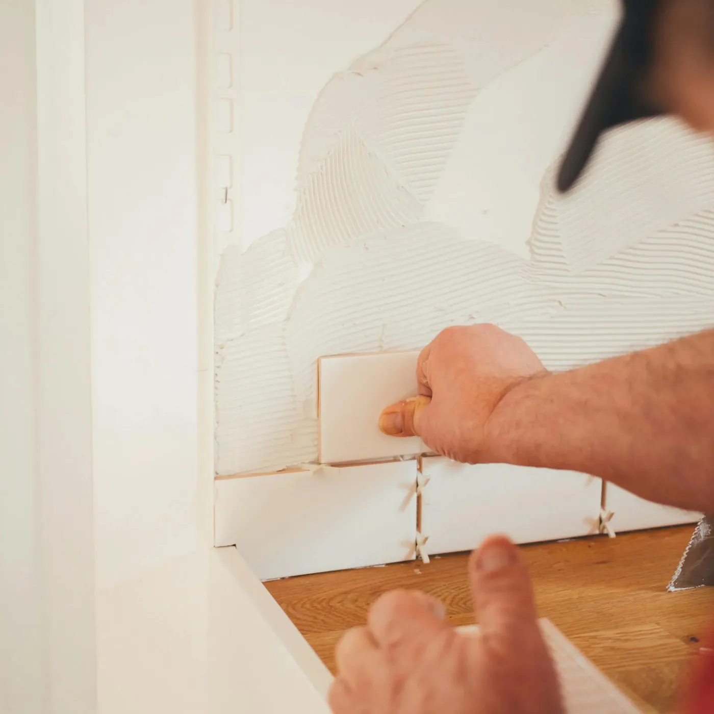 worker applying tile carefully