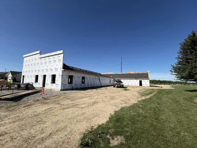 view of building facade with sloping roof and wrap