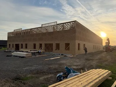 building construction taking place at sunset