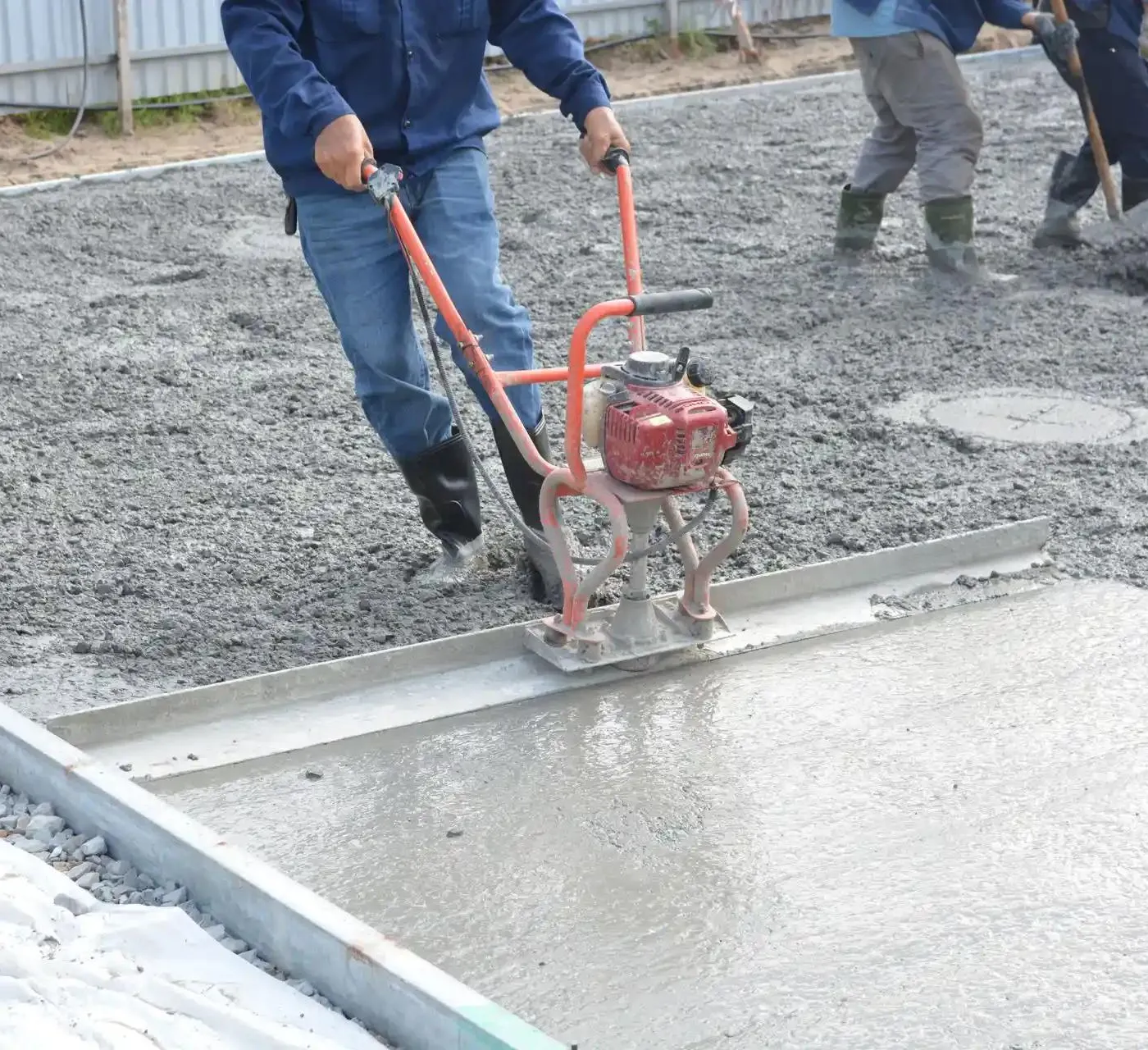 pouring and smoothing concrete with a smoothing machine