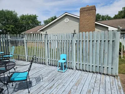 worn deck with peeling paint and weak fencing